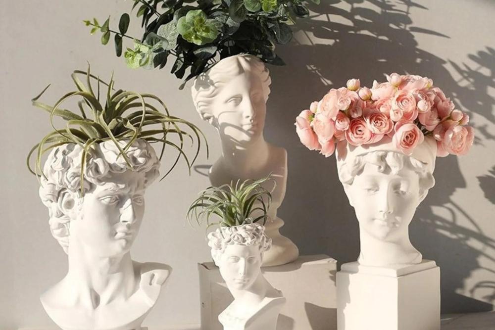 Greek god head vases with flowers