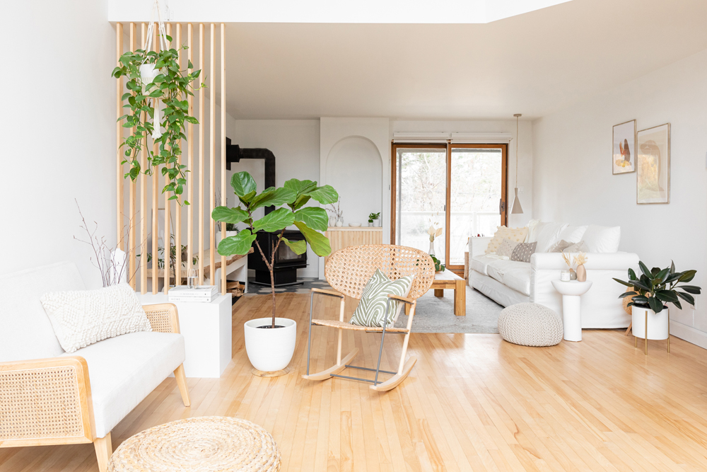 minimalist white living room with light-tone wood-slat room divider