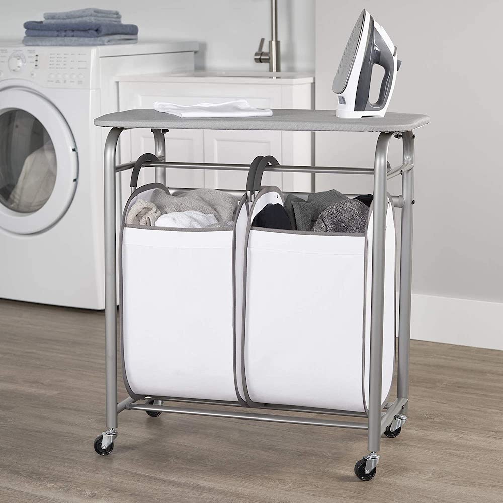 Neatfreak! Double Laundry Sorter with a built-in ironing board top that flips open to allow access to the easy carry hamper bags in a white laundry room