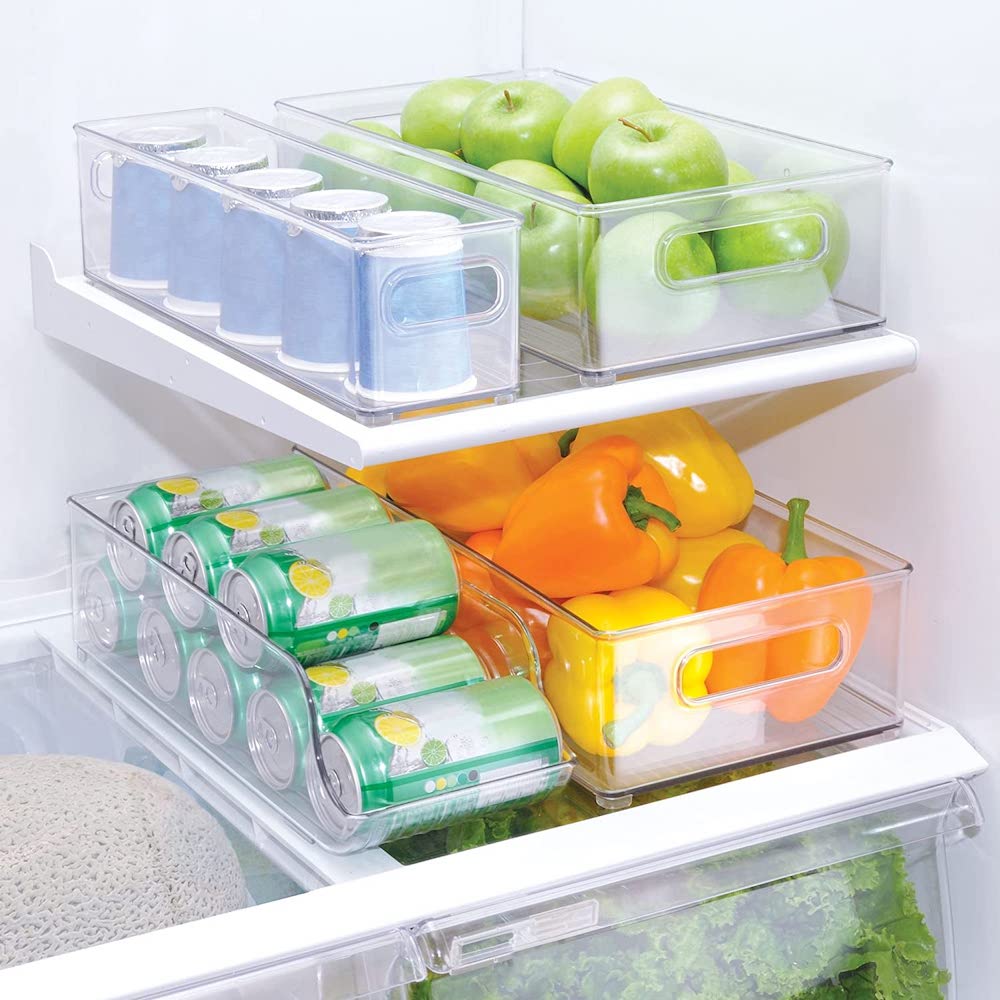 Transparent durable BPA-free plastic fridge containers from iDesign inside an open fridge and filled with drink cans, yellow and orange bell peppers, green apples and yogurt pots