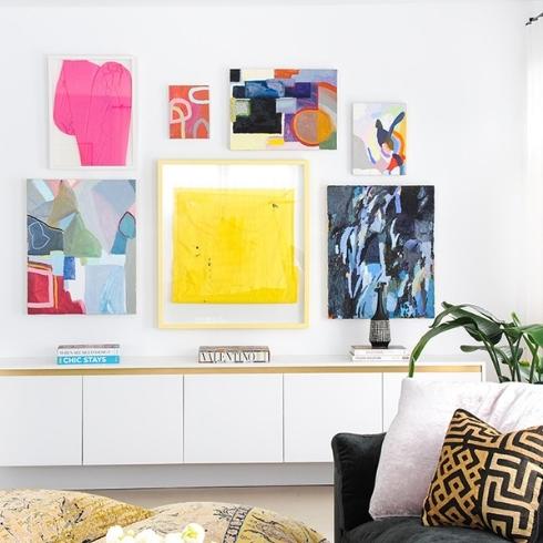 A gallery wall with bright coloured prints