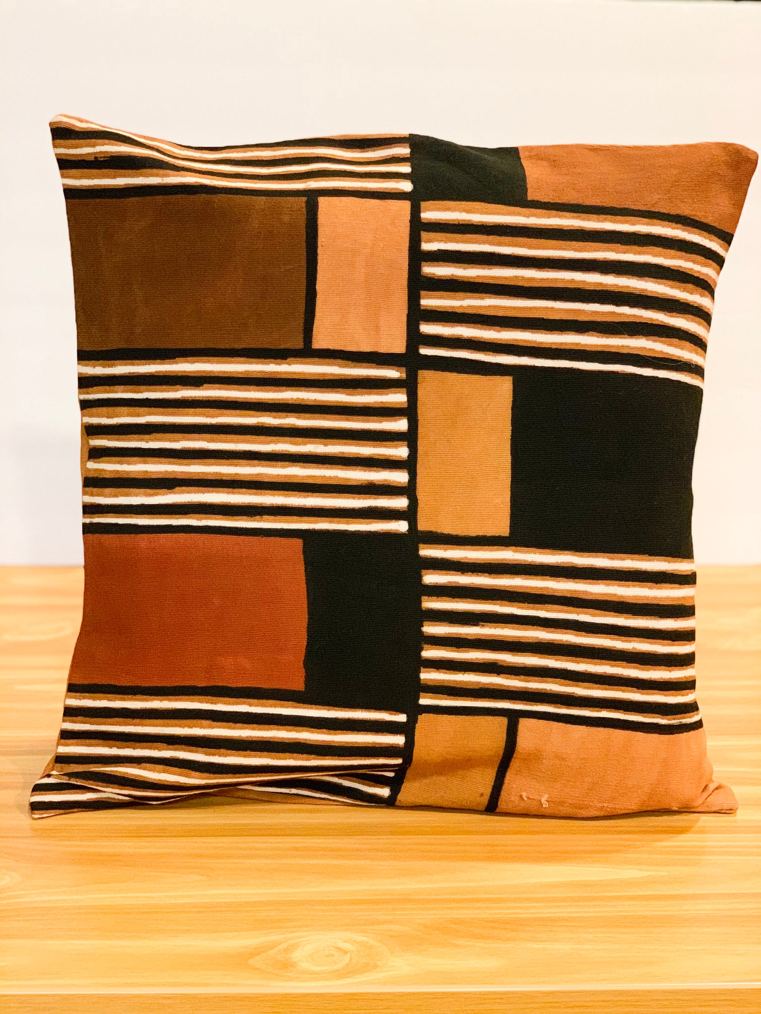 This earthy cushion cover combines ancient technique with contemporary design to craft a one-of-a-kind geometric Bògòlanfini piece.