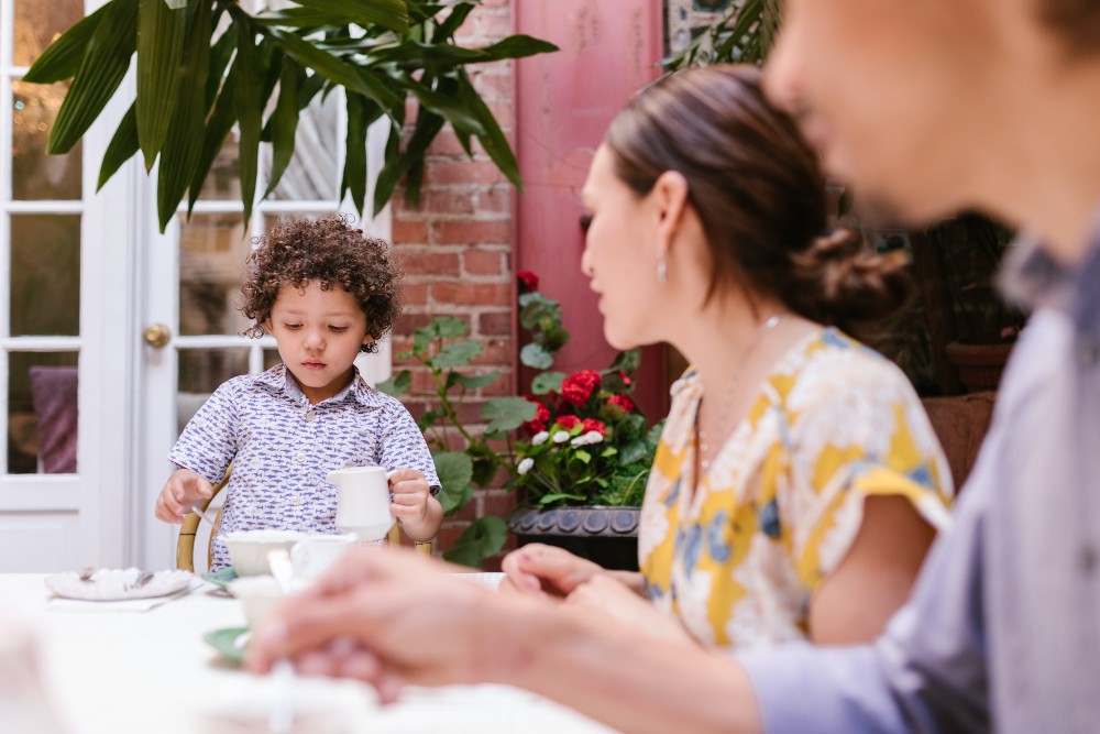 Child at table eating with parents