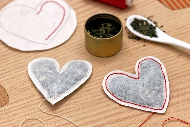 A canister of tea and two heart-shaped tea bags