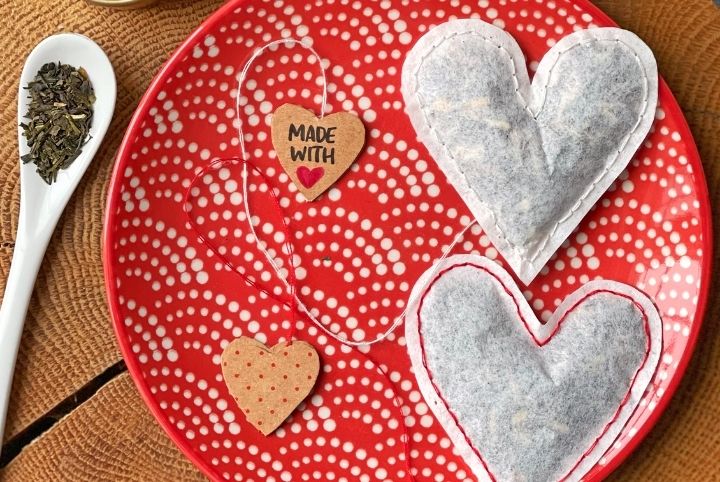 Two DIY heart-shaped tea bags on a red and white plate