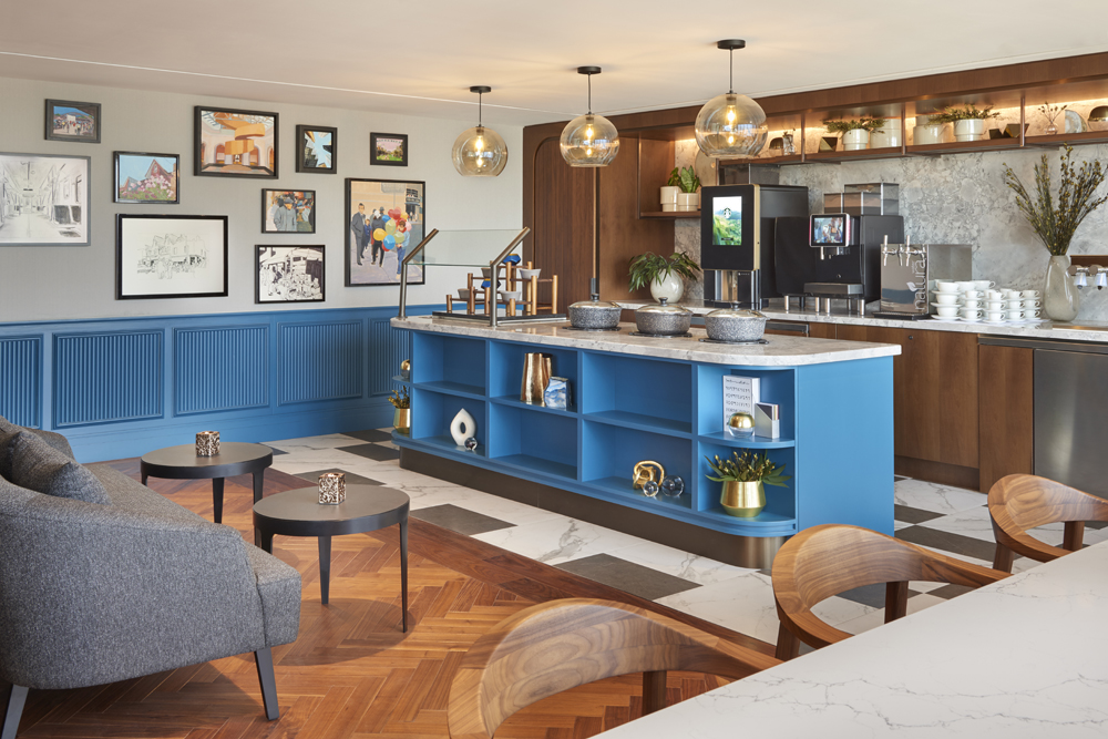 self serve bar with blue base and wainscotting, framed artwork wall