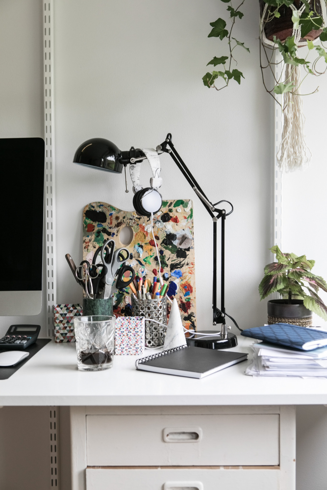 creative work space with a large desk lamp