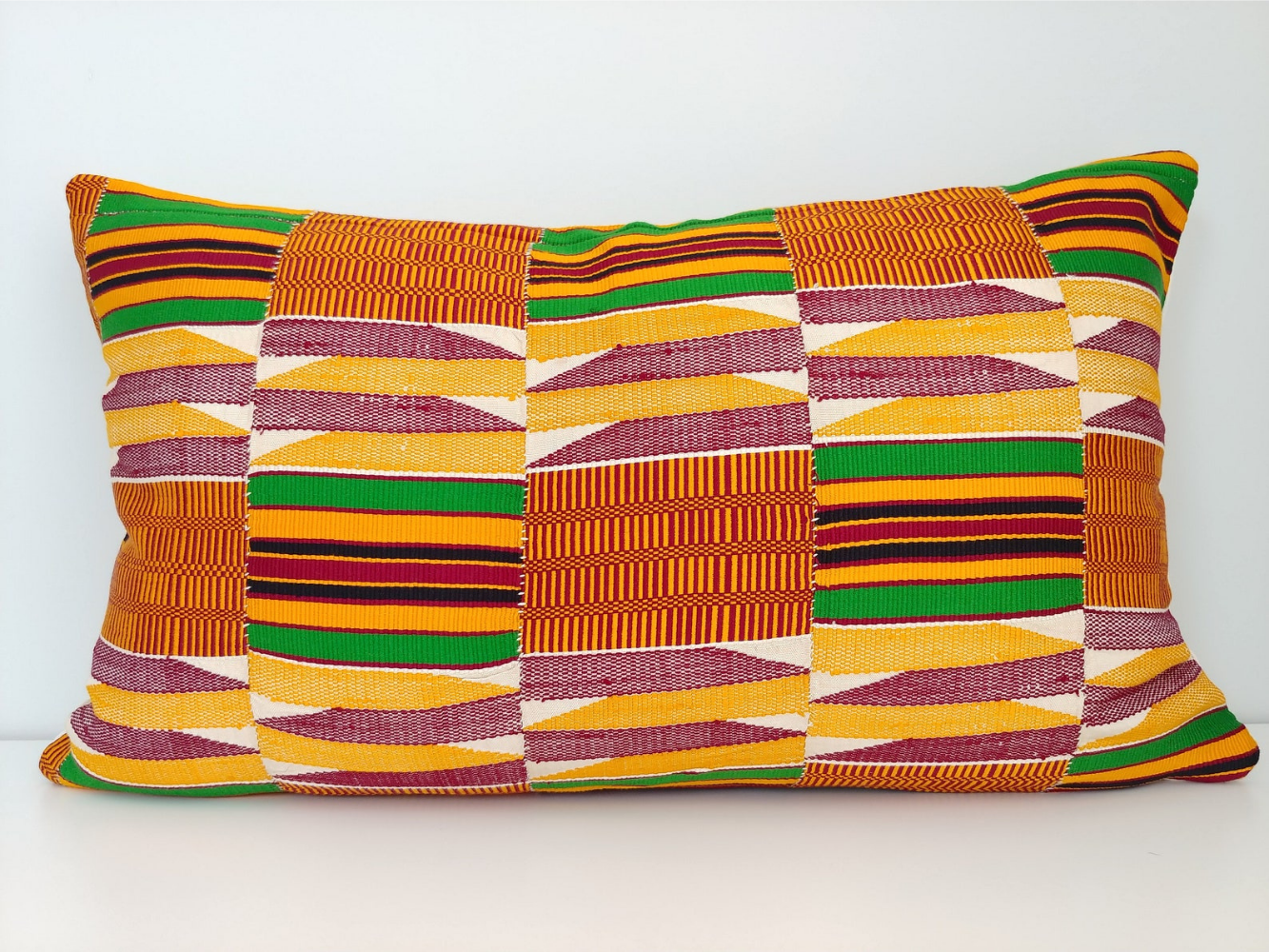 A gorgeous, geometric-patterned ewe kente pillowcase, also hailing from West Africa.
