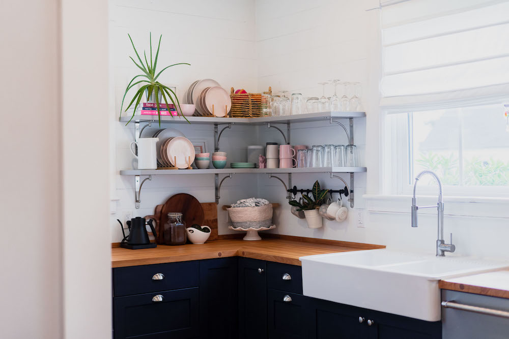 Kitchen with open shelves, shiplap and an apron sink