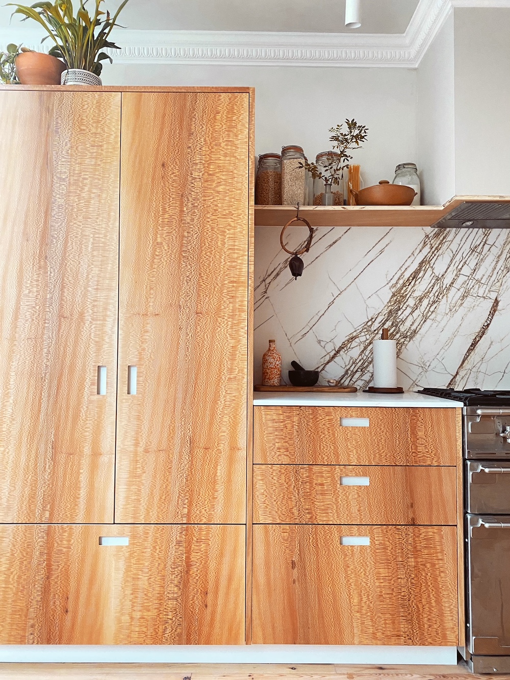 Wood Pantry and marble backsplash in kitchen