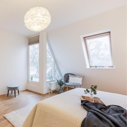 A white room with a Scandi-style light fixture