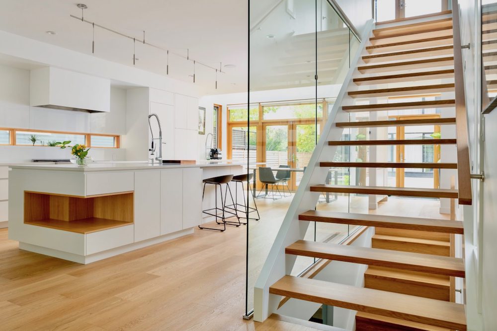 Light-filled kitchen and open stairs in laneway house