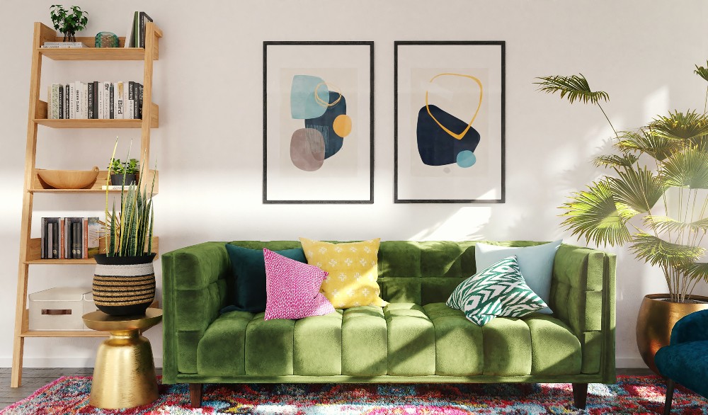 Green velvet sofa with pink, yellow and green pillows