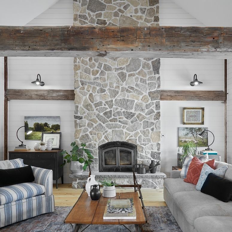 Renovated farmhouse living room with an exposed brick fireplace