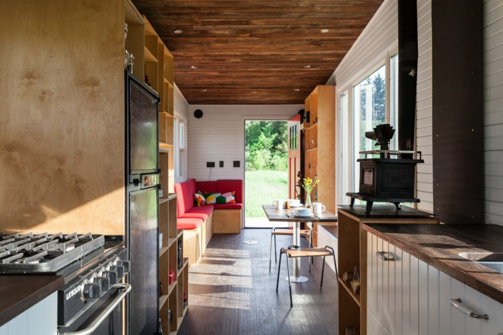 A sunny kitchen in an off-grid tiny-home, featuring an indoor stereo system powered by a solar panel on the roof of the house.
