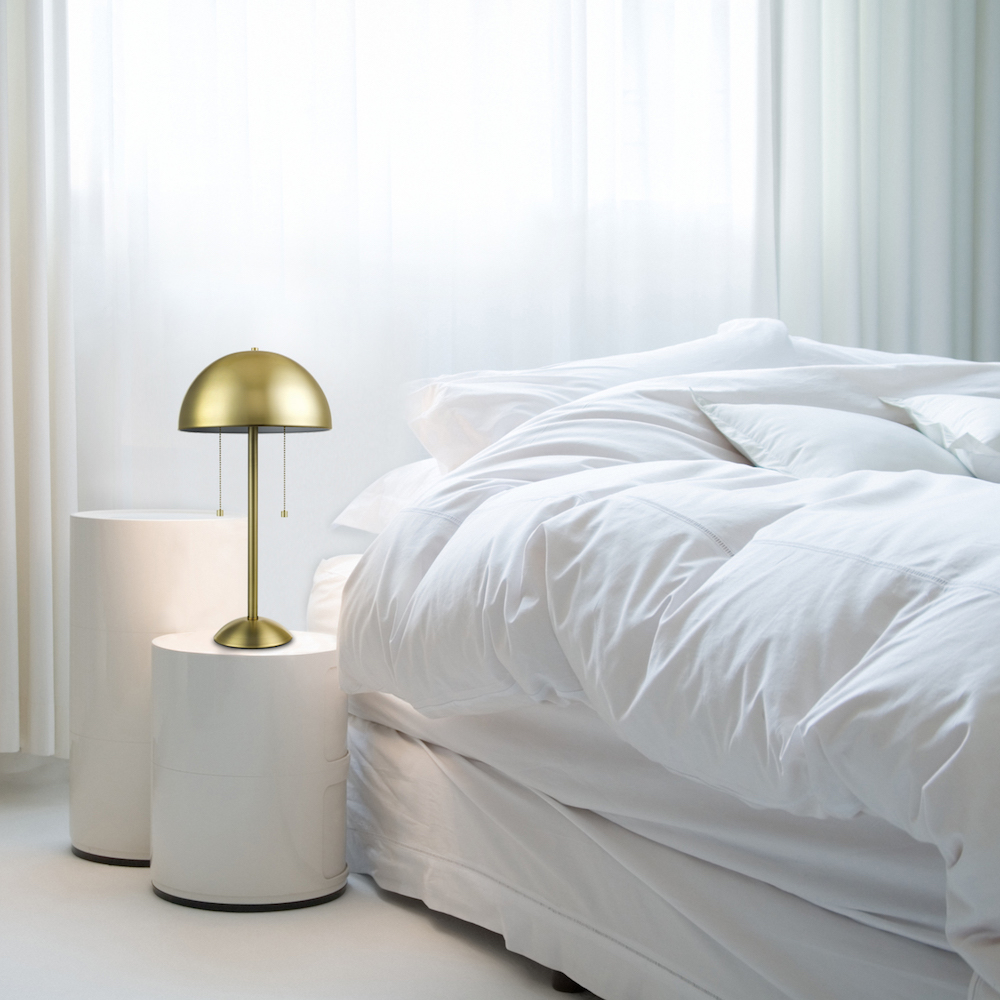 Gold mushroom-shaped table lamp in white bedroom