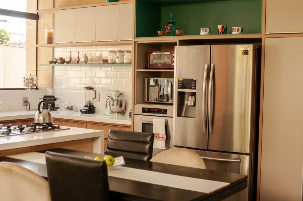 Kitchen with green walls and chrome fridge