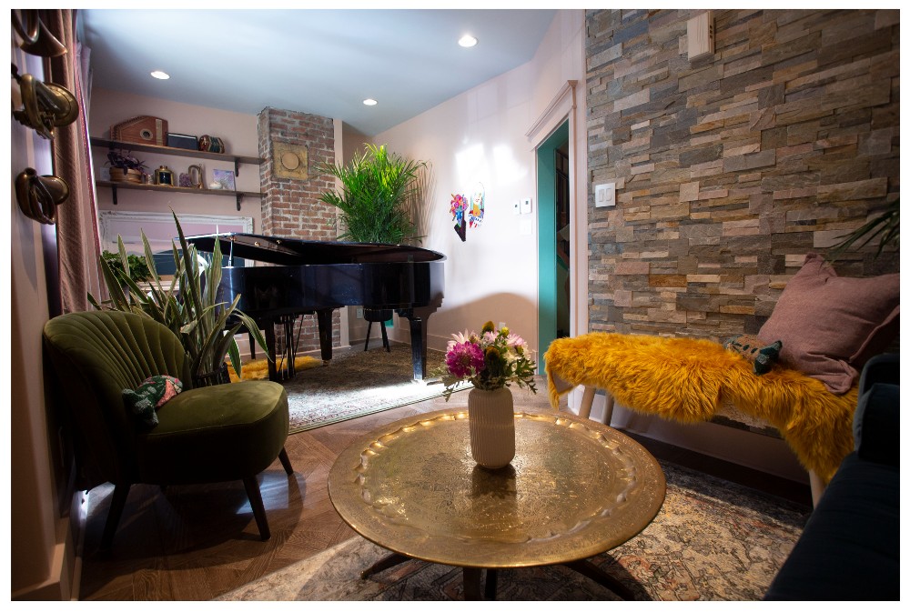 Living room with rock wall and jewel tone decor