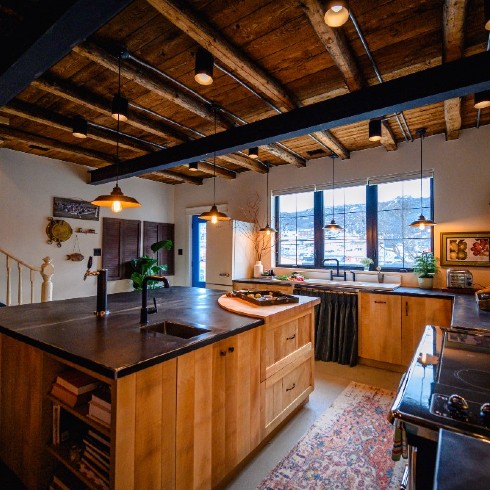 Big kitchen with exposed beams and industrial chic lights