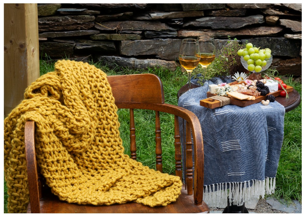 Cozy outdoor set up with blanket and wine