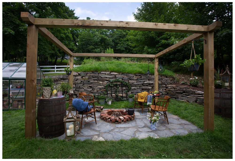 Firepit with chairs under an arbor