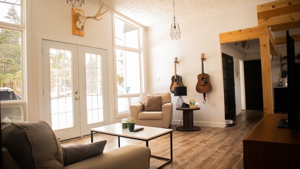 living room with guitars displayed on wall