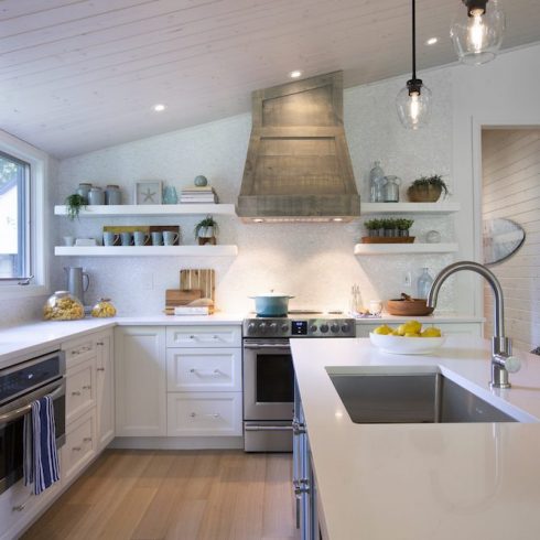 White renovated cottage kitchen with with large white island and light blue accents