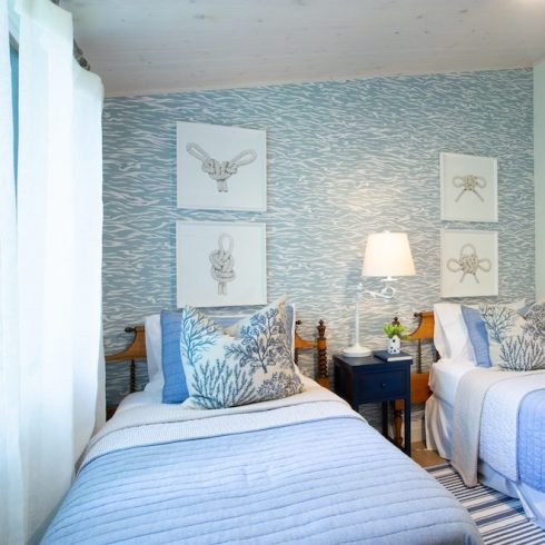 Cottage room with double beds and a blue and white feature wall