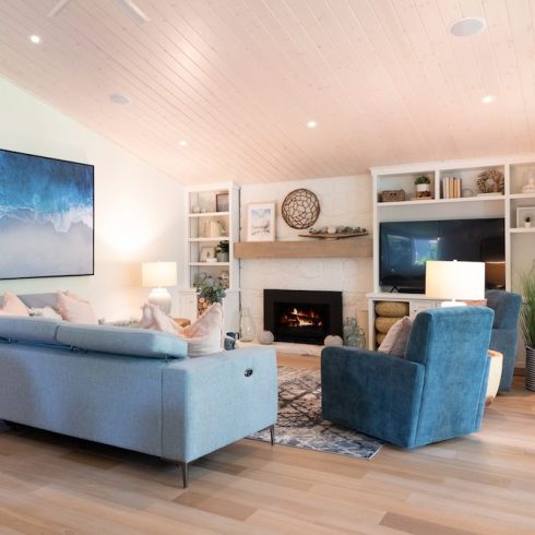 Blue and white beach themed living room with stone fireplace