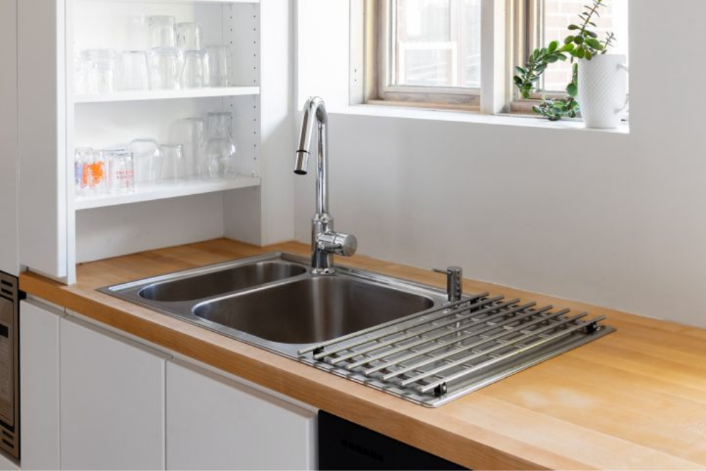 A clean stainless sink sink, clear of all dishes.