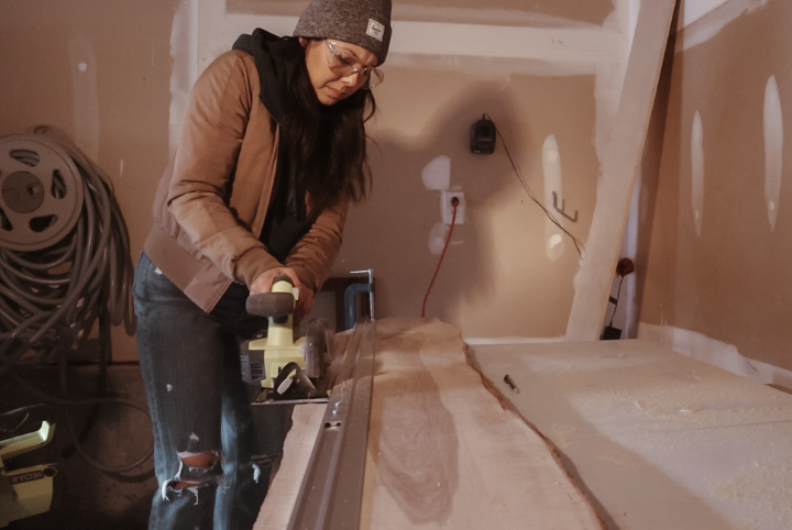 Courtney chooses with live edge of the wood slab she'd like to keep, and straightens out the opposite side. This is the side of the shelf that will sit flush against the wall.