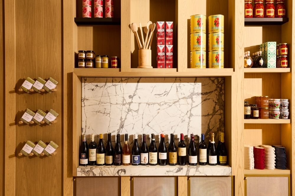 bar shelves with wine, wooden spoons jars, cans