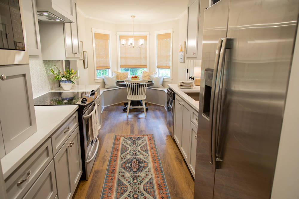 Galley kitchen with wood floors