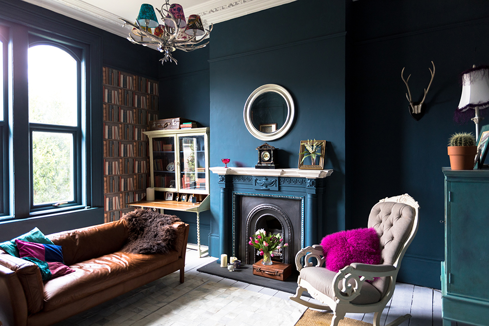 Dark blue living room with ornate fireplace