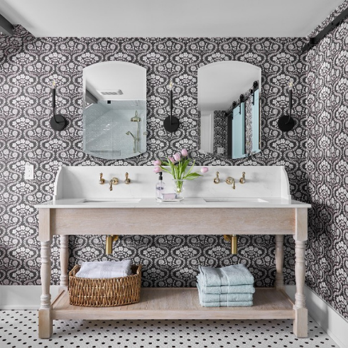 A modern farmhouse double vanity in a bathroom with charcoal grey and white floral wallpaper