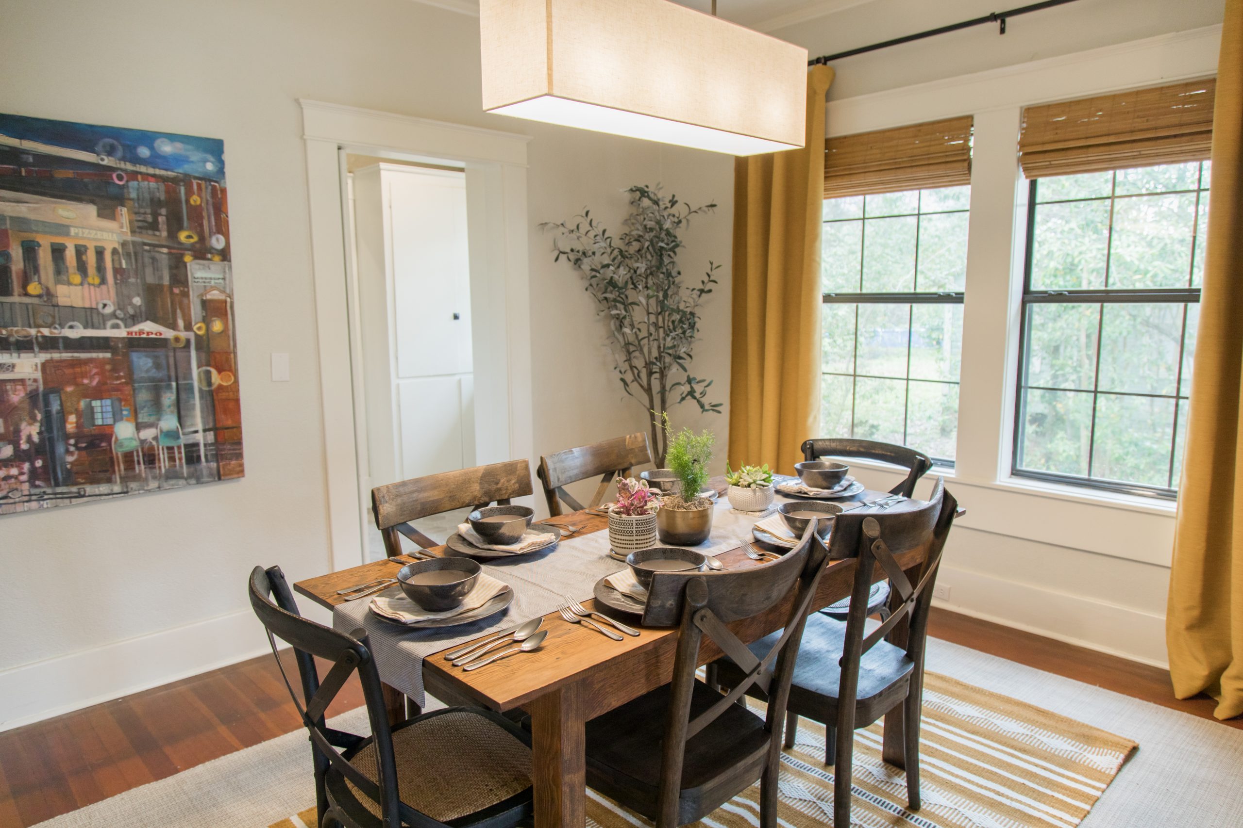Dining room with wood features and mustard yellow accents