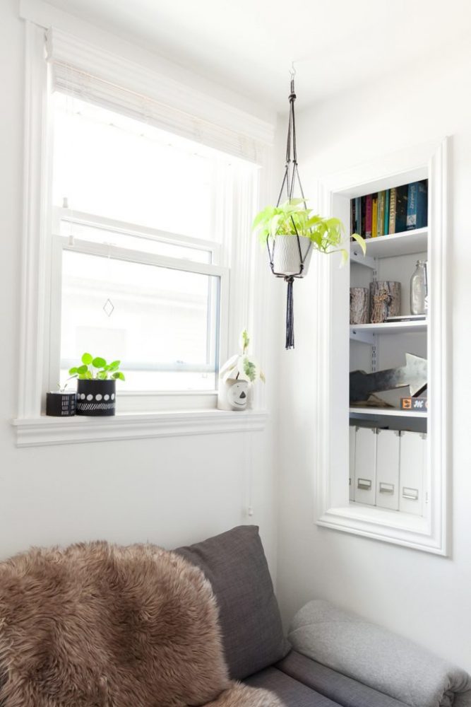 Bright book nook with macrame plant hanger and book shelf