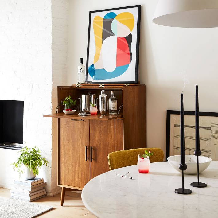 West Elm living room with mid-century bar cart and abstract art