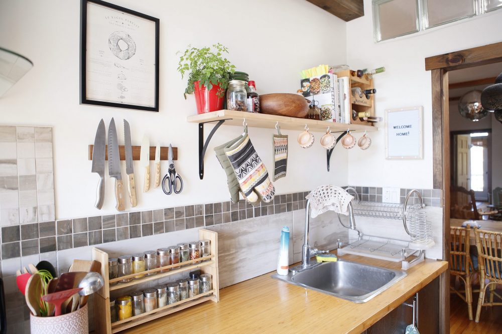 compact kitchen with shelf, hooks and magnetic knife holder on wall
