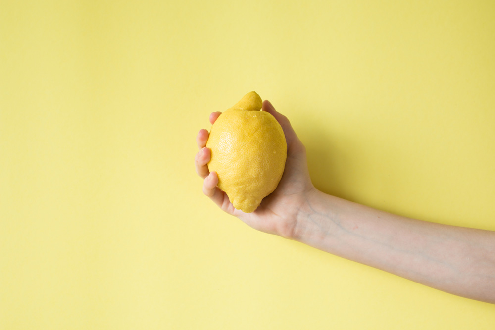 Person holding a lemon