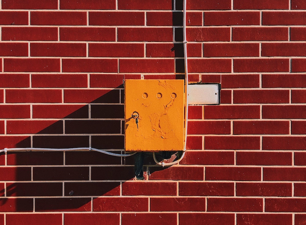 Old electrical box on brick wall