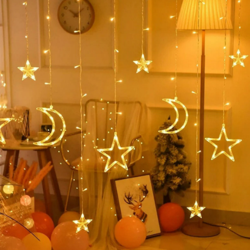 Fairy lights shaped like stars and crescent moons hanging as a curtain.