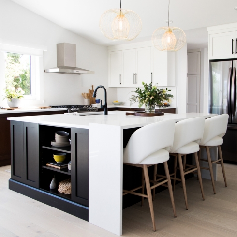A black and white kitchen with large island