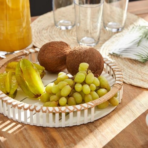 A white circular tray with different fruits