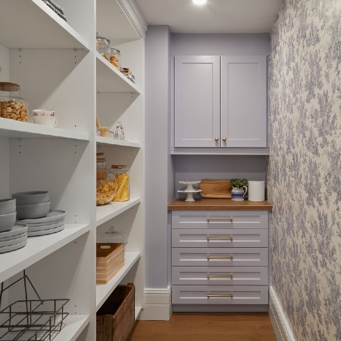 A pantry with toile wallpaper