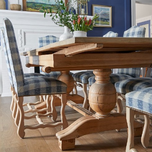 Antique dining table with blue check upholstered chairs