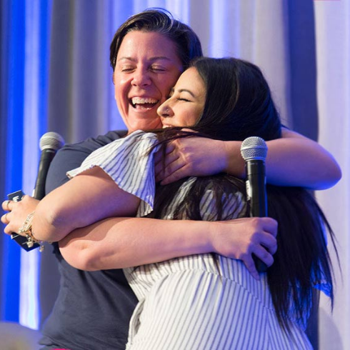 Mandy Rennehan giving a fan a big bear hug