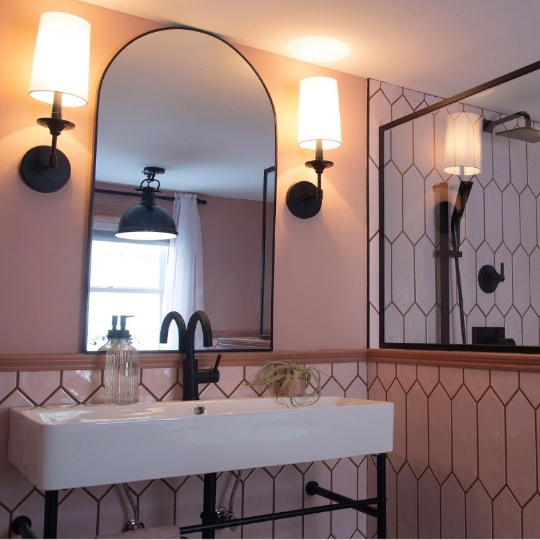 renovated bathroom with arch mirror