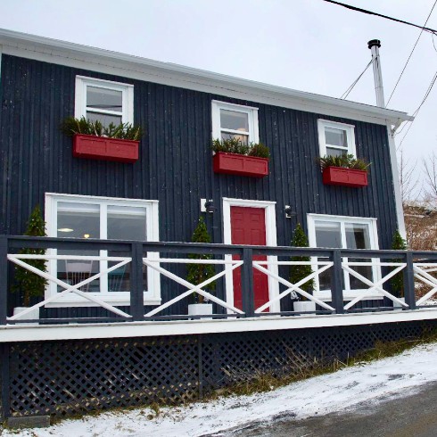 Newfoundland home in navy blue with white trim and red flower boxes