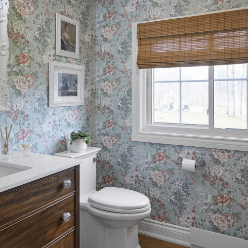 Bathroom with green and pink floral wallpaper and upcycled antique vanity